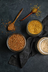 Jars with cereals on dark background
