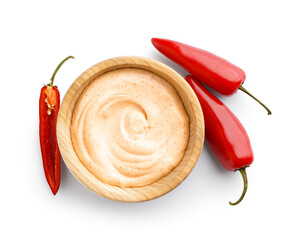 Wooden bowl of tasty chipotle sauce and fresh jalapeno peppers on white background