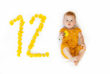 12-month-old baby girl in a yellow outfit. First birthday	