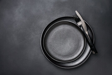 Background for menu Empty Black plat knife fork on dark stone table. Top view, copy space, Table setting. background for menu, layout, place for text , recipe background