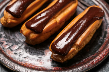 Plate with chocolate eclairs, closeup