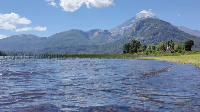 Lake in the Mountains with a volcano in the background. Blue sky. Summer vacation in nature.
