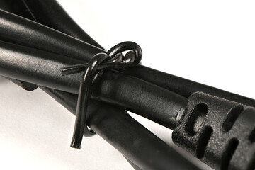Black power wire isolated on white background. Side view.