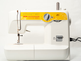 Electric sewing machine on a white background.