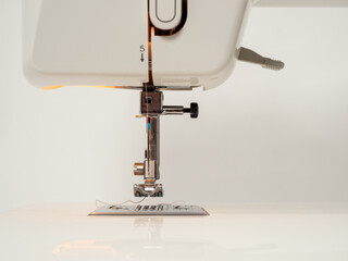 Electric sewing machine on a white background.