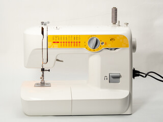 Electric sewing machine on a white background.