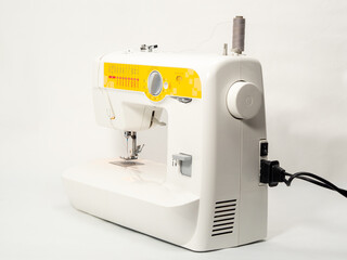 Electric sewing machine on a white background.