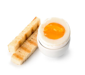 Holder with soft boiled egg and toasted bread on white background