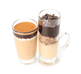 Shots of delicious pudding with chocolate and cinnamon isolated on white background