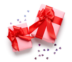 Gift boxes and sequins on white background. Valentine's Day celebration