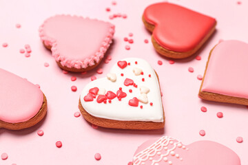 Composition with tasty heart shaped cookies and colorful sprinkles on pink background, closeup. Valentine's Day celebration