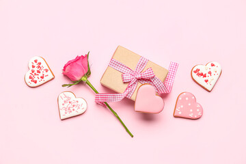Composition with tasty heart shaped cookies, rose flower and gift box on pink background....