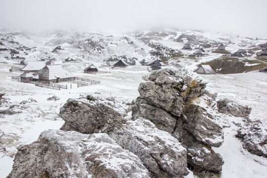 Velika planina mountain 1666 m in Kamnik Savinja Alps in Slovenia, winter hiking in herdsmen&rsquo;s huts village covered with snow