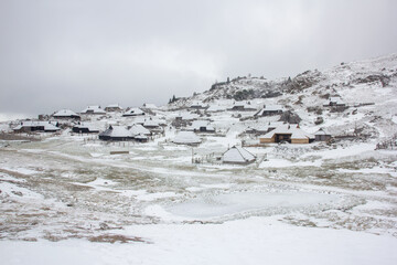 Velika planina mountain 1666 m in Kamnik Savinja Alps in Slovenia, winter hiking in herdsmen’s huts village covered with snow