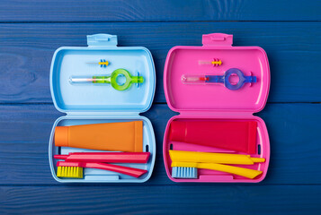 Oral care. Travel cosmetic bag with a toothbrush and toothpaste in a case. Composition on a blue...