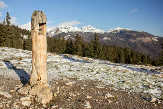 Velika planina mountain 1666 m in Kamnik Savinja Alps in Slovenia, winter hiking in herdsmen&rsquo;s huts village covered with snow, with white mountain peaks