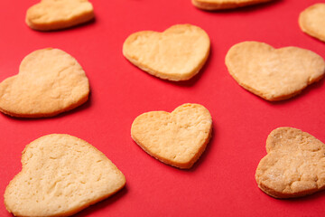 Sweet heart shaped cookies on red background, closeup. Valentines Day celebration