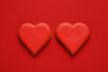 Obraz na płótnie Canvas Sweet heart shaped cookies on red background. Valentines Day celebration