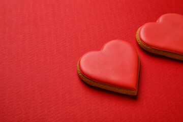 Sweet heart shaped cookies on red background, closeup. Valentines Day celebration