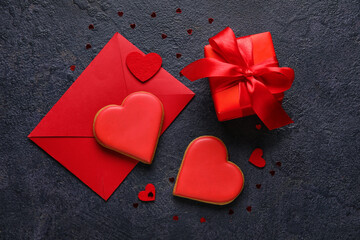 Composition with sweet cookies, envelope and gift box on dark background. Valentines Day celebration