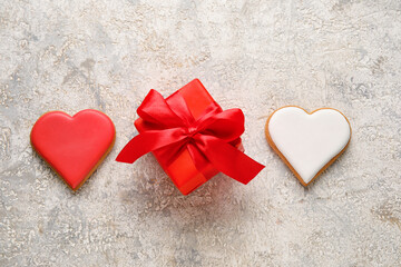 Tasty heart shaped cookies and gift box on light background. Valentines Day celebration