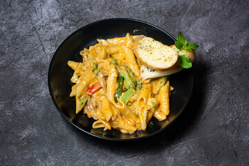 Creamy Pasta with garlic bread served in dish isolated on grey background top view of indian and bangladesh food