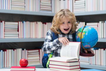 Excited pupil. Back to school. Funny little child from elementary school with book. Education. Kid study and learning.