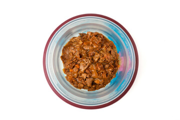 Wet food for cats and dogs in a bowl on a white background. Top view.	