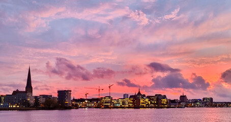 sunset over the skyline of rostock city harbor