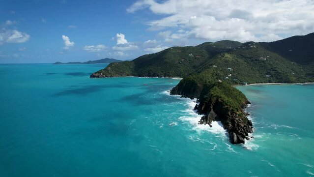 Aerial footage of waves crashing over beach and coastline on Tortola, British Virgin Islands