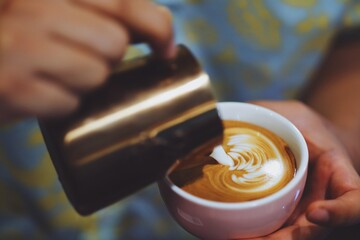 Barista making coffee latte art.