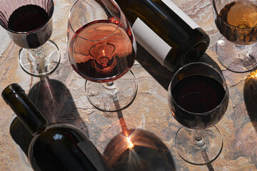 Glasses of  rose,white and red wine  with bottles. Wine degustation concept. Selective focus.