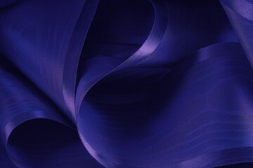 Abstract background. Swirling roll of  satin fabric.Selective focus.