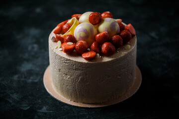biscuit cake decorated with strawberries and chocolate balls