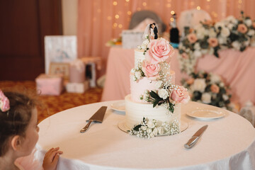 little girl looking at wedding cake