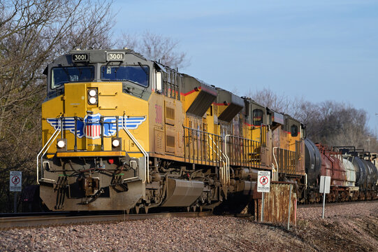 Three Union Pacific Railroad locomotives lead a freight train through a rural section of northeastern Illinois on its journey from Chicago. 