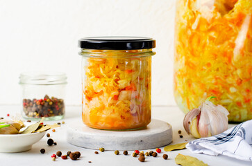 Sauerkraut, Shredded cabbage, apples, and carrots on bright rustic background, Fermented Food,...