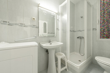 White-toned bathroom with walk-in shower, mirror, and top-loading washing machine