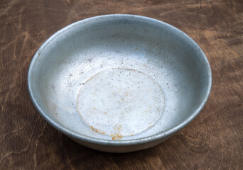 Dishes made of aluminum .An empty dog bowl on the table.