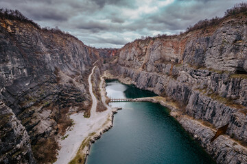 Fototapeta na wymiar Aerial view of Velka Amerika,Big America,limestone quarry.Grand Canyon of Czech Republic.Labyrinth of caves,lake with crystal clear water.Popular tourist place,picturesque Czech nature,steep cliffs