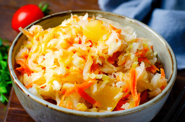 Sauerkraut, Shredded cabbage, apples, and carrots on dark rustic background, Fermented Food, Healthy Eating