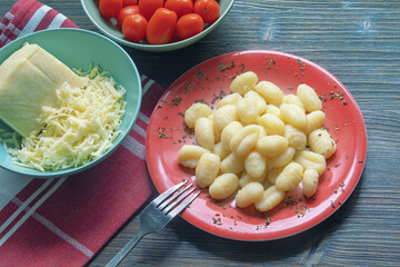 Balkan cuisine. Njoke ( potato gnocchi, dumpling ), cheese and cherry tomatoes . Copy space