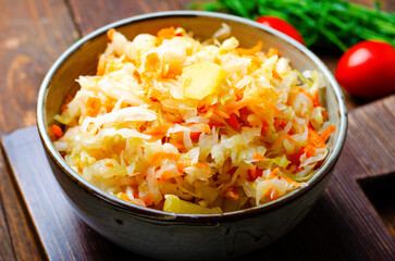 Sauerkraut, Shredded cabbage, apples, and carrots on dark rustic background, Fermented Food, Healthy Eating