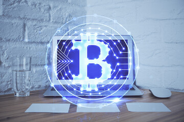 Multi exposure of blockchain and crypto economy theme hologram and table with computer background....
