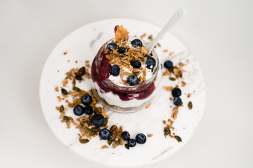 Healthy Snack Lifestyle Image. Yogurt parfait with granola, blueberry preserves and fresh blueberries. Top down view of parfait.