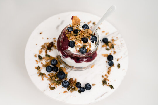 Healthy Snack Lifestyle Image. Yogurt Parfait With Granola, Blueberry Preserves And Fresh Blueberries. Top Down View Of Parfait.