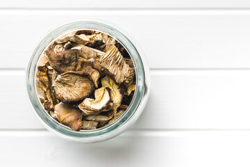 Sliced dried mushrooms in jar. Top view.