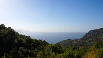 Fototapeta na wymiar seascape, view of the mediterranean sea from the height of the forested mountains