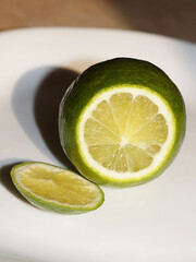 cut fresh lime on a white plate close-up
