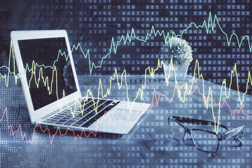 Financial graph colorful drawing and table with computer on background. Double exposure. Concept of international markets.